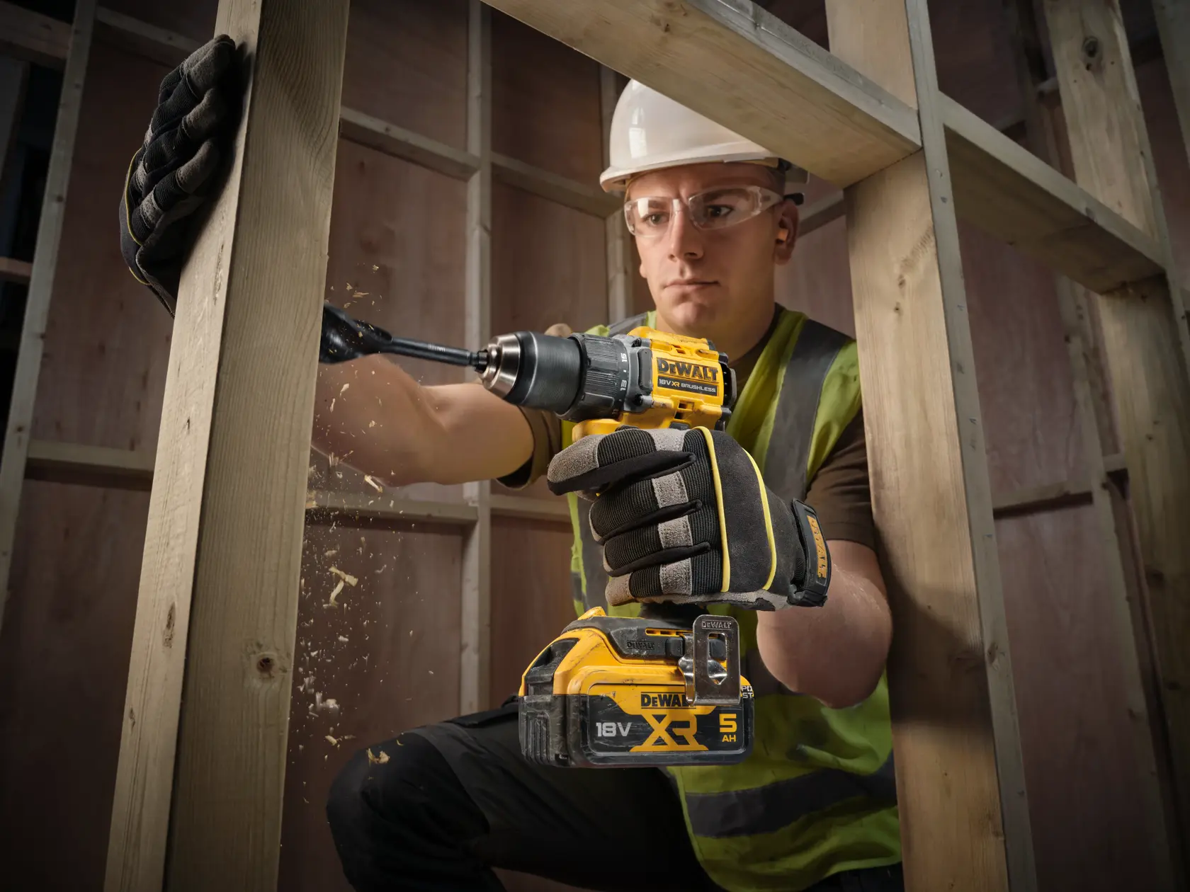 Taladro DEWALT usado en madera. SKUs: DCD794P2T, DCD794P2T-QW. Obrero con cara difuminada.